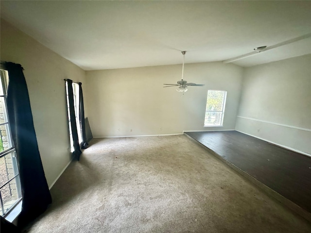 carpeted empty room featuring ceiling fan and vaulted ceiling