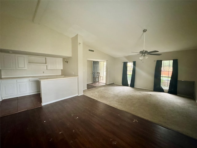 unfurnished living room featuring dark hardwood / wood-style flooring, high vaulted ceiling, and ceiling fan