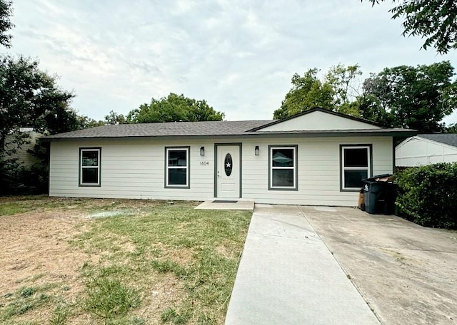 ranch-style home featuring a front yard