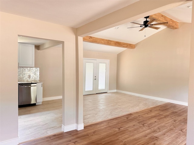 foyer with ceiling fan, french doors, lofted ceiling with beams, and light wood-type flooring