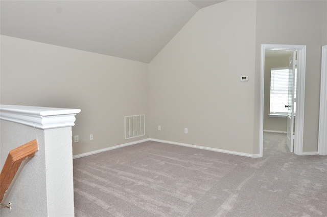 bonus room featuring light carpet and vaulted ceiling