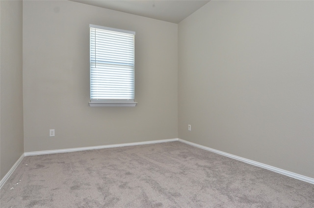 spare room featuring light colored carpet