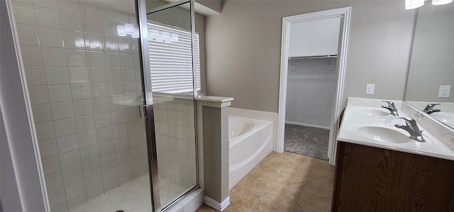 bathroom featuring tile patterned floors, independent shower and bath, and vanity