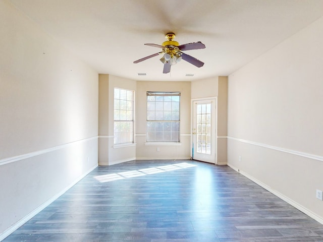 unfurnished room with dark hardwood / wood-style floors and ceiling fan