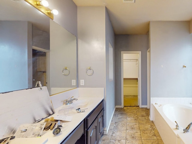 bathroom featuring a tub and vanity