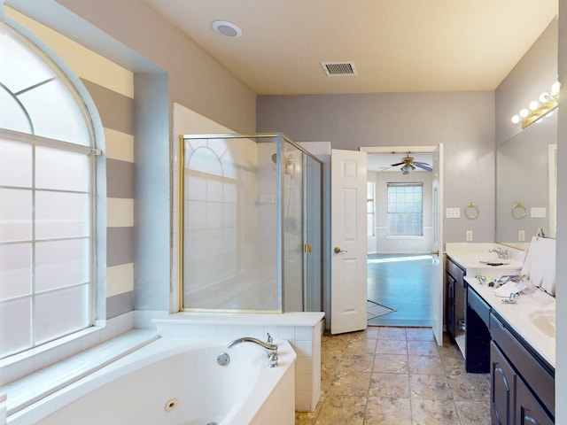 bathroom featuring ceiling fan, vanity, and shower with separate bathtub