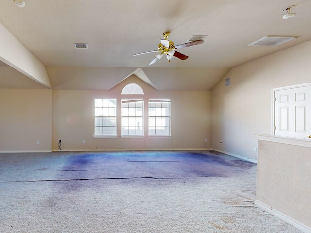 carpeted spare room featuring ceiling fan and vaulted ceiling