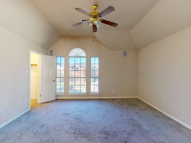 empty room featuring ceiling fan, light carpet, and lofted ceiling