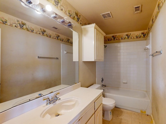 full bathroom featuring tile patterned flooring, vanity, toilet, and tiled shower / bath