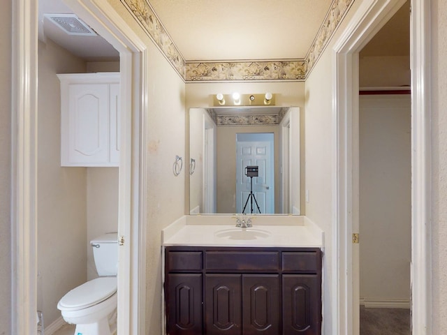 bathroom with vanity and toilet