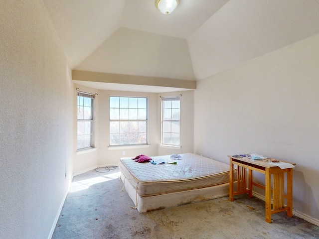 bedroom with light colored carpet and lofted ceiling