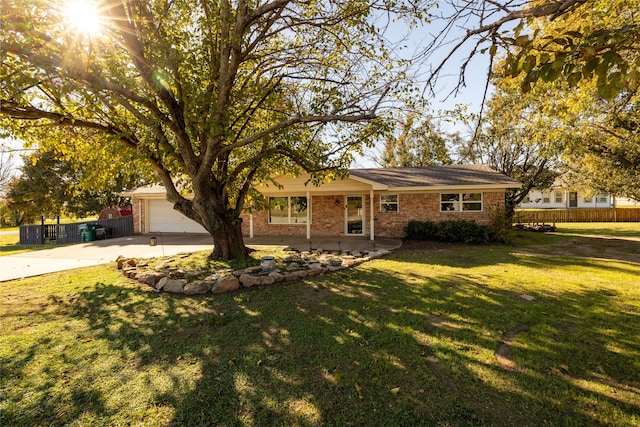 single story home with a front yard and a garage