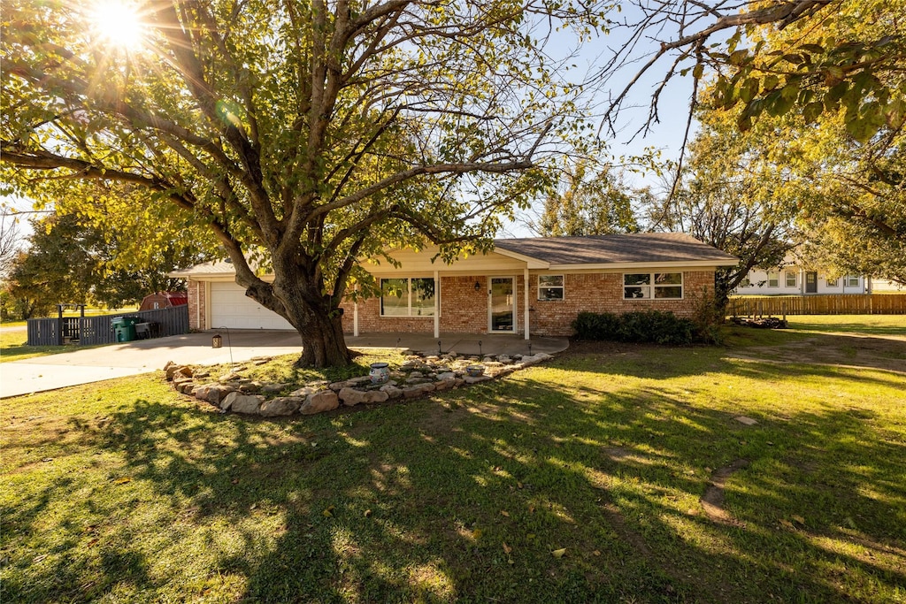 single story home with a garage and a front yard