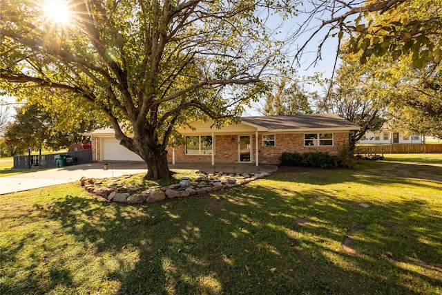 single story home with a garage and a front yard