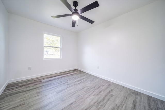 spare room with ceiling fan and hardwood / wood-style floors