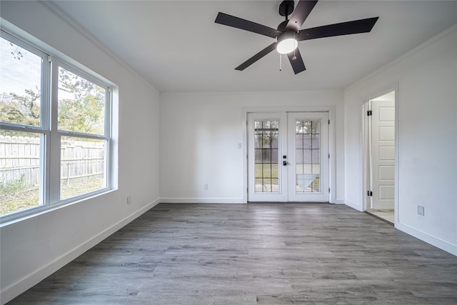 spare room featuring crown molding, wood-type flooring, french doors, and ceiling fan