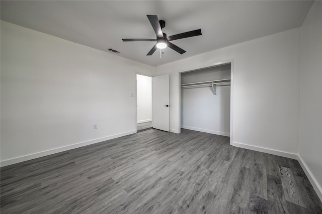 unfurnished bedroom with ceiling fan, hardwood / wood-style floors, and a closet