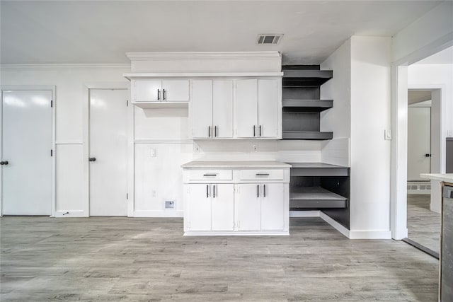 kitchen featuring white cabinetry, crown molding, and light hardwood / wood-style flooring