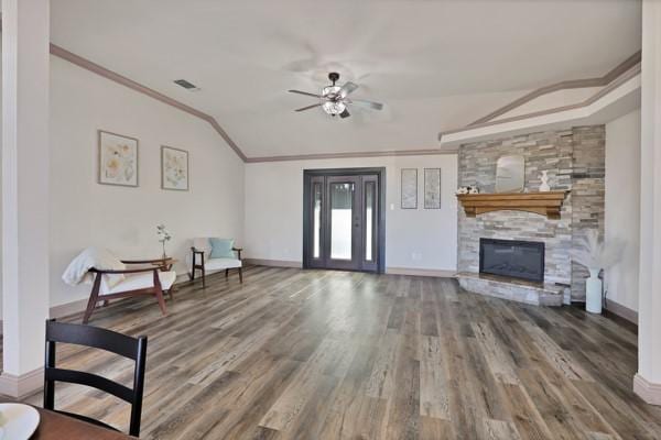 sitting room featuring crown molding, a stone fireplace, ceiling fan, and hardwood / wood-style flooring