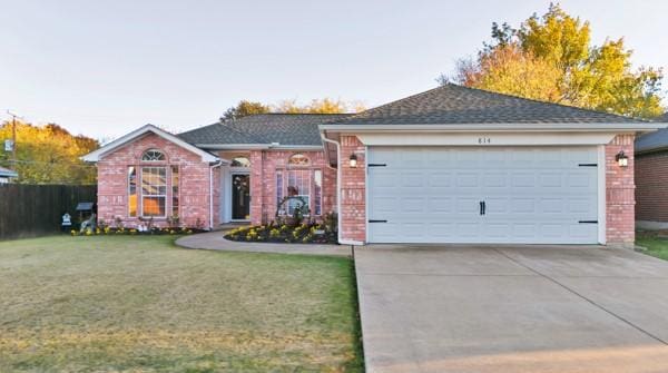 ranch-style home featuring a garage and a front yard