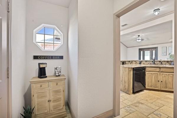 kitchen with light brown cabinetry, sink, dishwasher, and ceiling fan