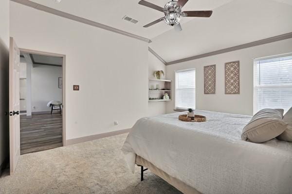 bedroom featuring multiple windows, crown molding, lofted ceiling, and carpet flooring