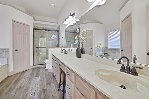 full bathroom with toilet, vanity, shower with separate bathtub, and hardwood / wood-style floors