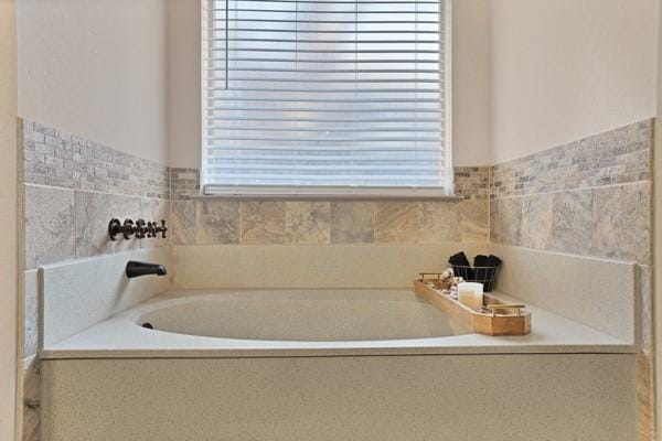 bathroom featuring a bathtub and a wealth of natural light