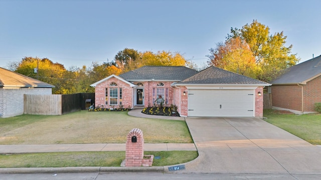 single story home with a garage and a front lawn