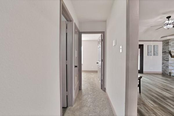 hallway with light hardwood / wood-style flooring