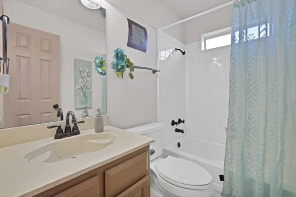 full bathroom with vanity, shower / bath combo, and toilet