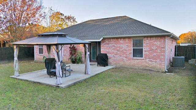 back of house featuring a gazebo, a lawn, a patio, and central air condition unit