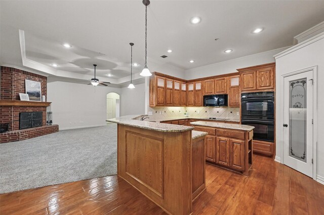 3421 Mindy Ln, Midlothian, TX 76065 - kitchen featuring a sink, brown cabinets, black appliances, and a peninsula