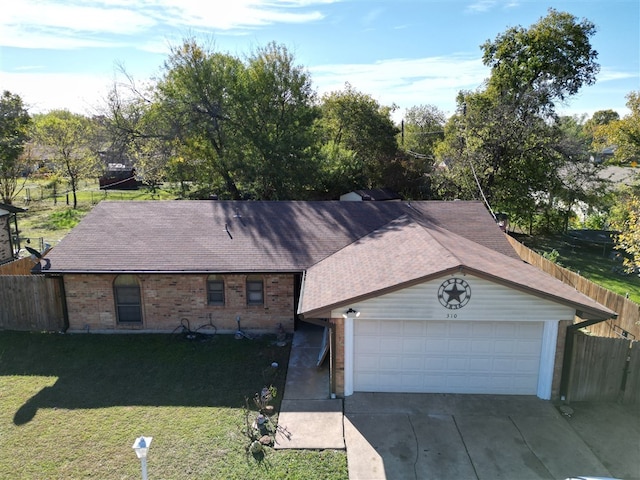 ranch-style home featuring a garage and a front lawn