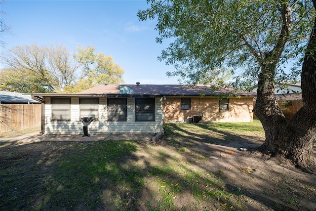 back of property with a yard and cooling unit