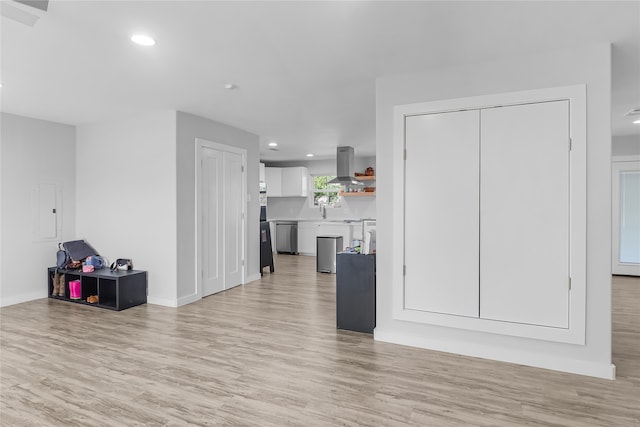 living room featuring electric panel and light hardwood / wood-style flooring