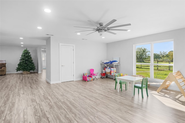 game room featuring light hardwood / wood-style floors and ceiling fan