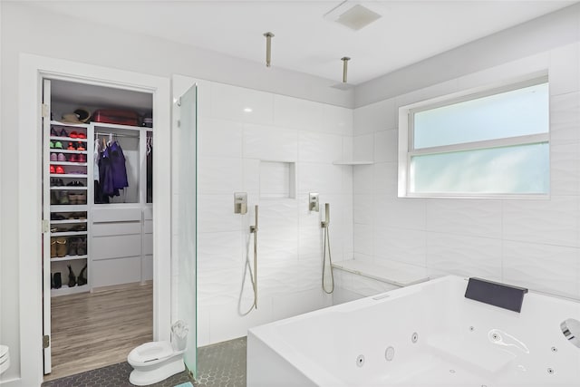 bathroom with plus walk in shower, wood-type flooring, and tile walls