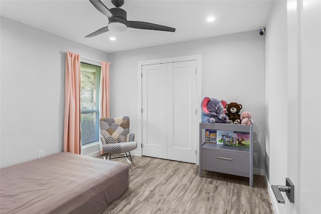 bedroom featuring ceiling fan, a closet, and light hardwood / wood-style flooring