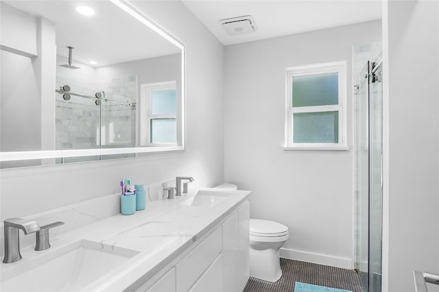 bathroom featuring tile patterned flooring, vanity, toilet, and an enclosed shower