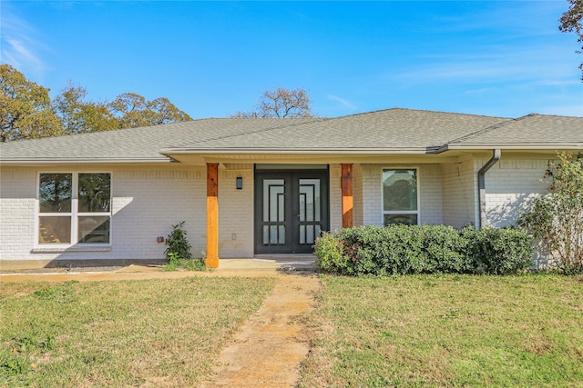 ranch-style home with a front lawn