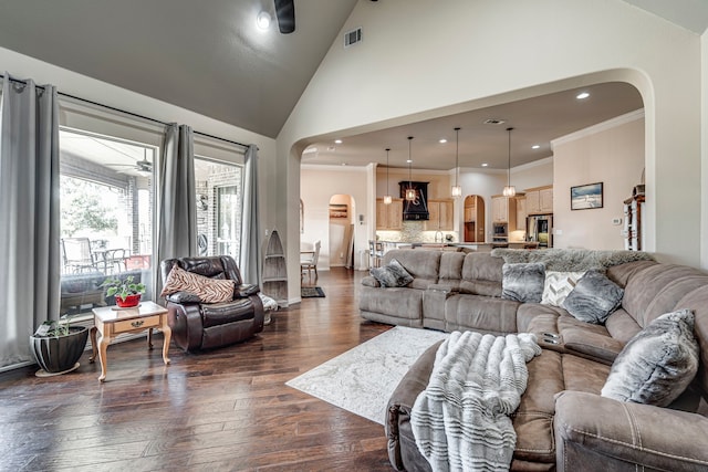 living room with ceiling fan, dark hardwood / wood-style flooring, high vaulted ceiling, and crown molding