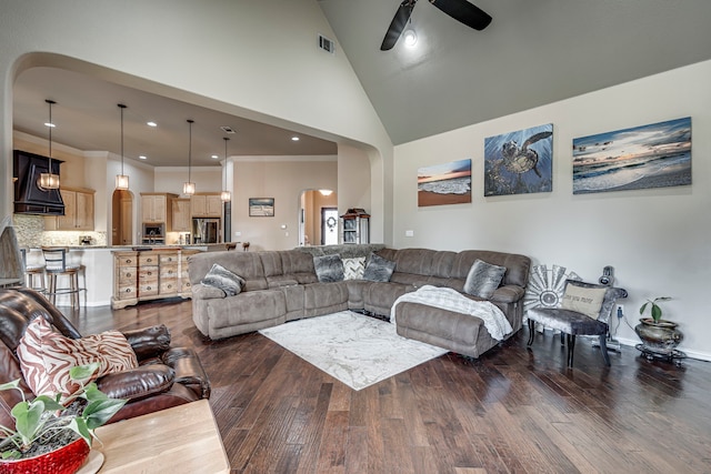 living room with ornamental molding, high vaulted ceiling, ceiling fan, and dark wood-type flooring