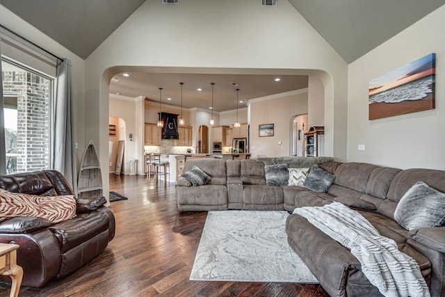 living room featuring dark hardwood / wood-style flooring, high vaulted ceiling, and ornamental molding