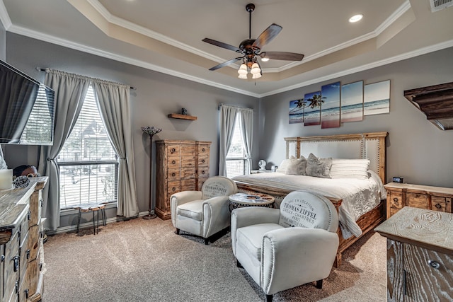 carpeted bedroom with crown molding, ceiling fan, and a tray ceiling