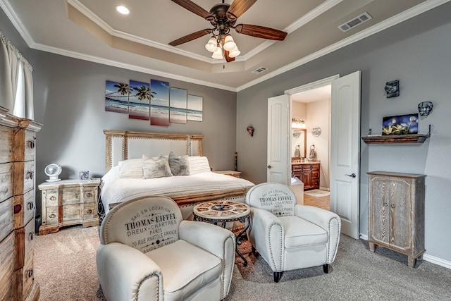 bedroom featuring carpet flooring, ensuite bath, ceiling fan, and crown molding