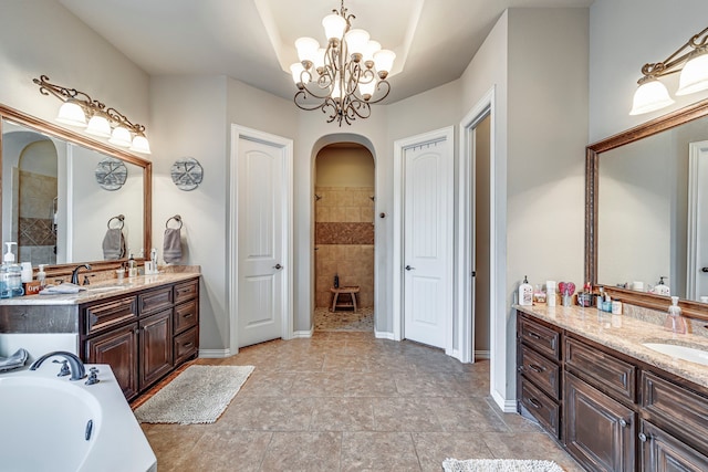 bathroom featuring a chandelier, shower with separate bathtub, vanity, and tile patterned floors