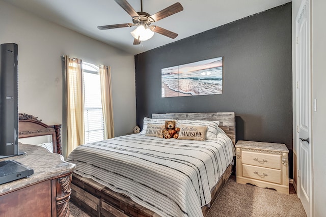 bedroom with dark colored carpet and ceiling fan