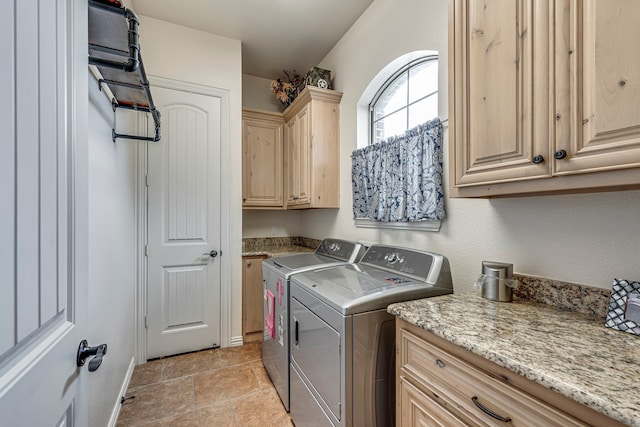 clothes washing area with cabinets and washing machine and clothes dryer