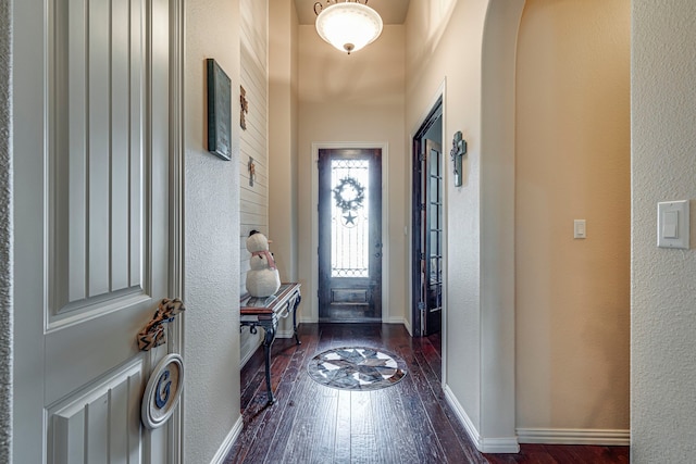 entryway with dark hardwood / wood-style flooring